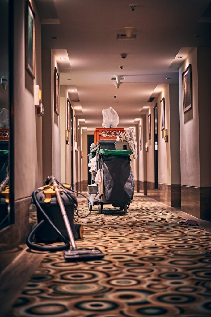 hotel hallway with a vacuum cleaner