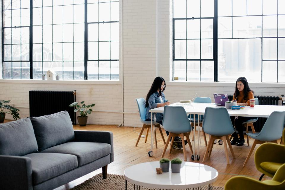 Two women working in bright, modern office.