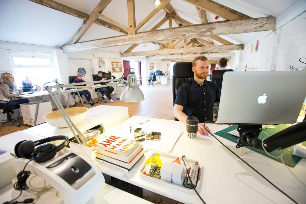 modern, open-plan office space with several people working at their desks