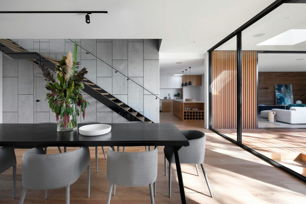 modern dining room with table, chairs, and flowers